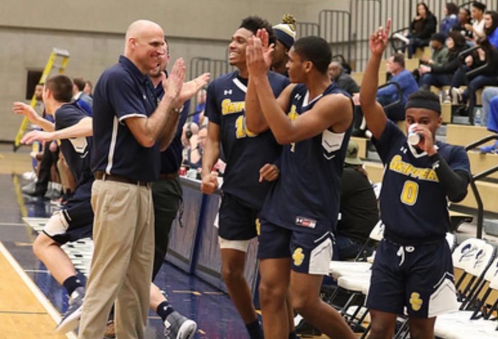 Dale Vos (Athletics Director, Head Men's Basketball and Men's Golf Coach) celebrates as his team wins the District Basketball Tournament in 2019.
