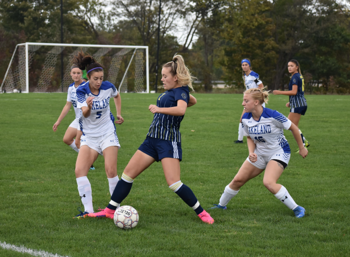 An sc4 women's soccer play and two Lakeland soccer players in action