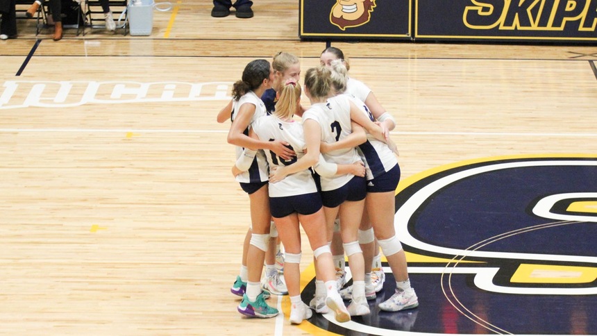 SC4 volleyball team in a huddle on the court in their game against jackson college